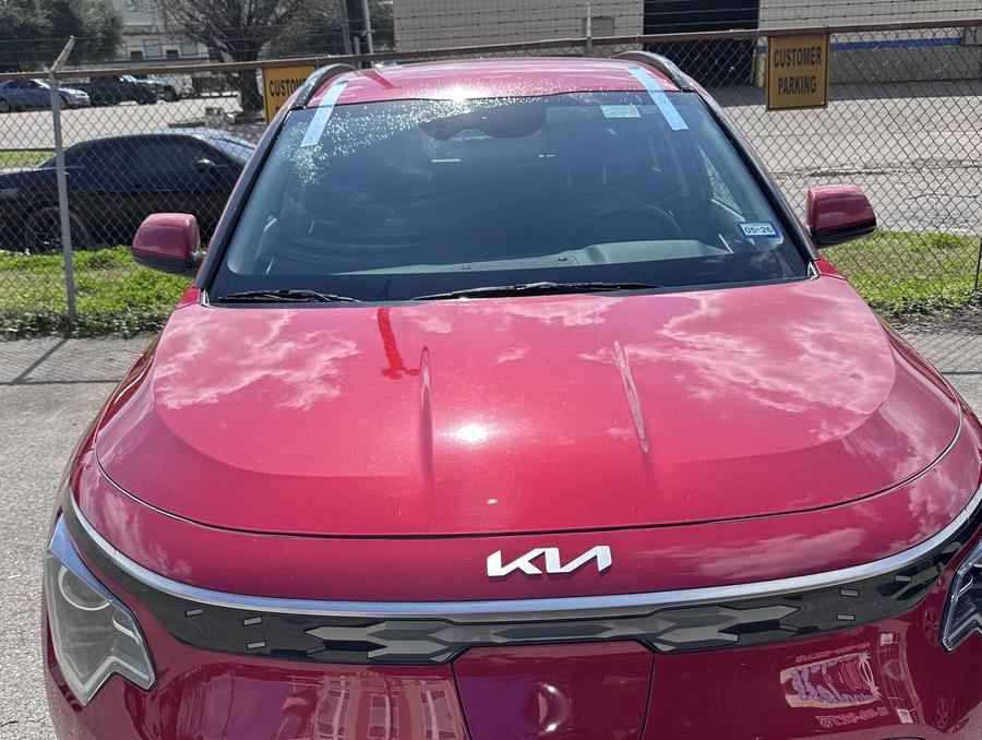 Red Kia Niro with a new windshield