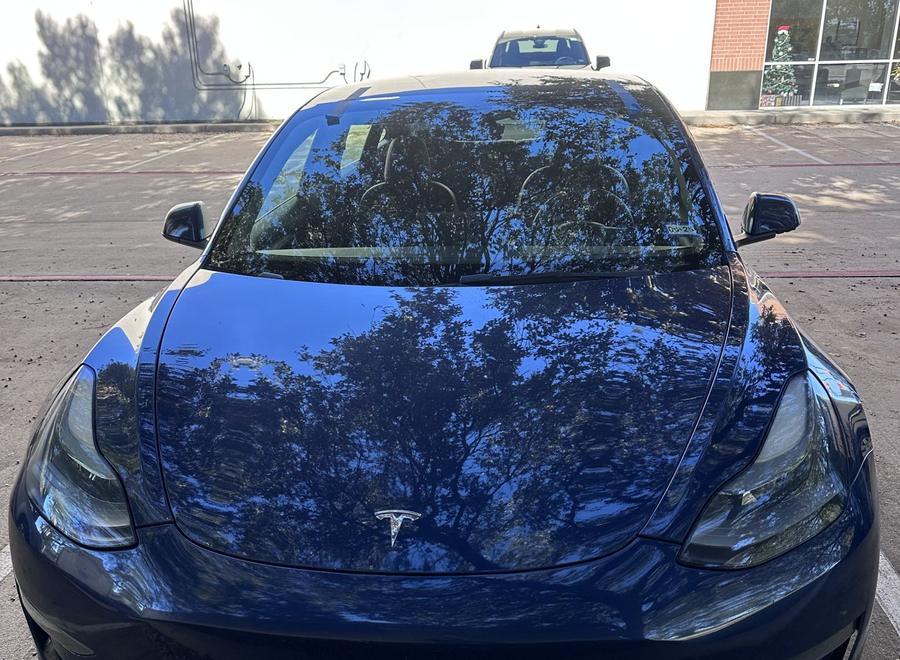 Blue Tesla Model 3 with a new windshield